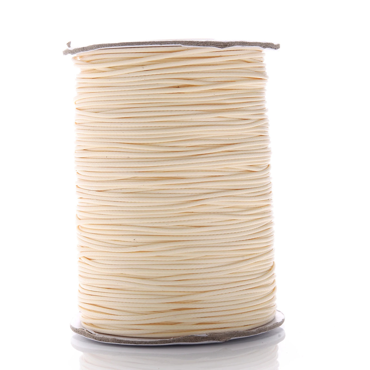 A spool of thin, light beige waxed cotton cord for jewelry making.