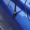 Close-up of a black carbon fiber antenna base cover mounted on a blue Dodge RAM 1500 vehicle.