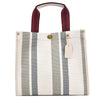 A white canvas tote bag with gray stripes and a maroon strap.