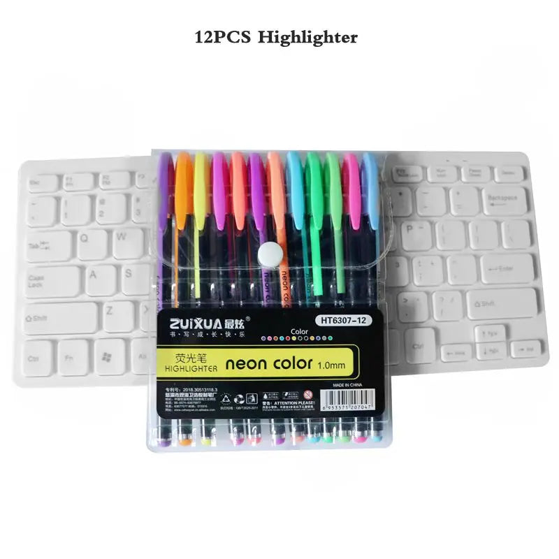A set of 12 neon colored gel highlighters in a plastic case displayed next to a keyboard.