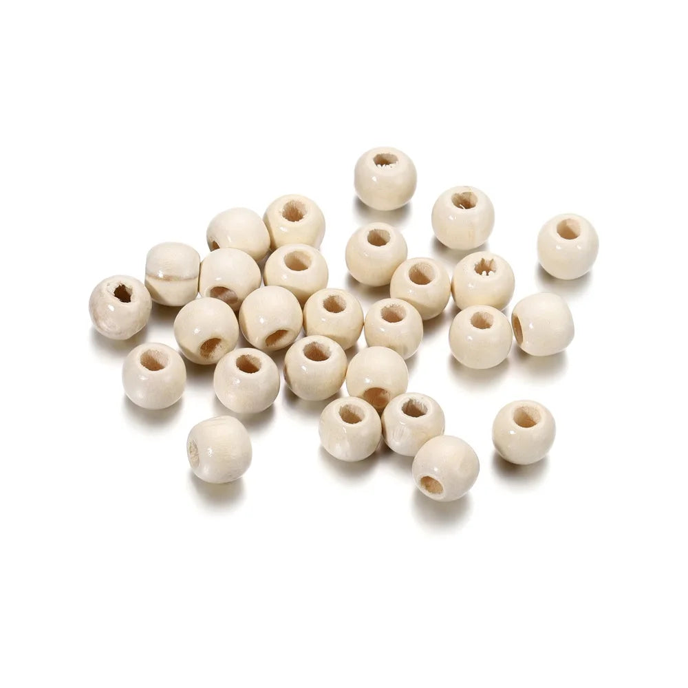 A collection of natural wooden spacer beads in various sizes and shades, arranged on a white background.