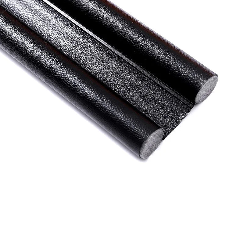 A close-up view of a black flexible door bottom sealing strip or weatherproofing draft guard.