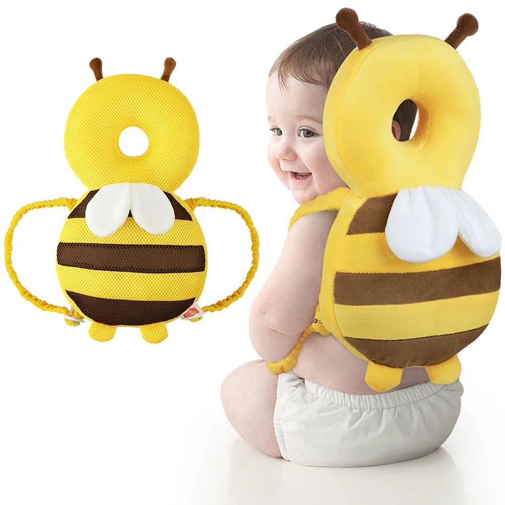 A yellow bee-shaped head protector backpack for a toddler, featuring black stripes and white wings.