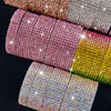 A close-up of various colored crystal rhinestone ribbon stickers arranged in a row.