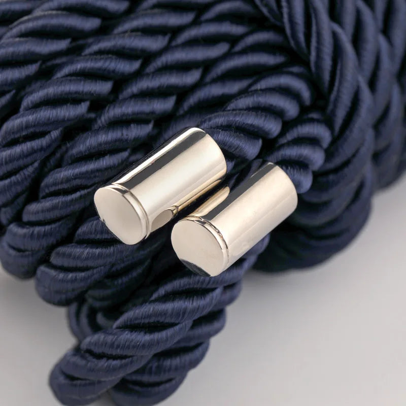 Two silver rope ends tied together in a dark blue braided cord