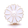 A white flower-shaped metal snap button with a pearl center and gold trim for jewelry making.
