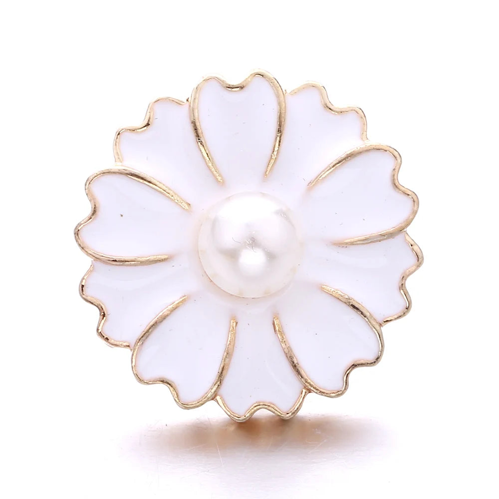 A white flower-shaped metal snap button with a pearl center and gold trim for jewelry making.