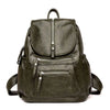 A dark olive green faux leather women's backpack with multiple zippered compartments.