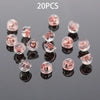 20 pieces of clear silicone rubber ear back stoppers with copper rings displayed on a dark surface.