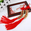Red handmade knot with gold coins displayed in a wooden frame for Chinese Feng Shui wealth
