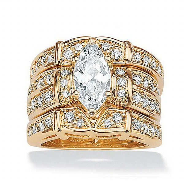 A vintage 14K gold bridal ring set featuring a marquise lab diamond center stone surrounded by pave diamonds.