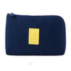 A dark blue compact travel cable organizer bag with a yellow tag visible on the front.