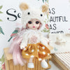 A white fluffy fashion doll with pink hair and an orange polka dot skirt is displayed next to a small bird.