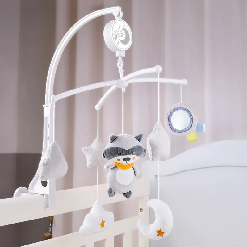 A white musical crib mobile featuring a rotating rattle bracket with soft, cloud-shaped animal charms hanging from it.