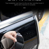 Close-up of a hand installing a black door edge protector strip on a car door.