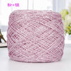 A ball of pink metallic silk crochet yarn with a shimmering silver thread for knitting and macrame.