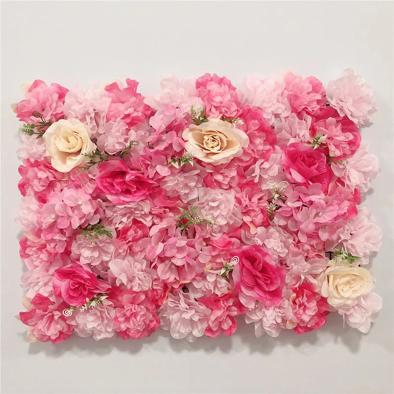A dense wall panel of pink and light pink silk rose flowers for weddings and events.