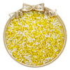 A small gold-rimmed dish filled with a mix of yellow and white glass seed beads for jewelry making