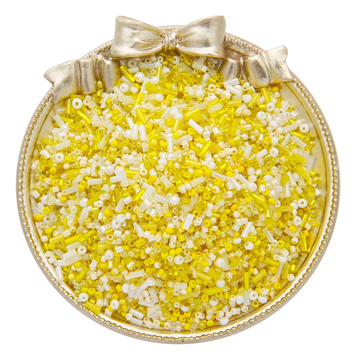 A small gold-rimmed dish filled with a mix of yellow and white glass seed beads for jewelry making