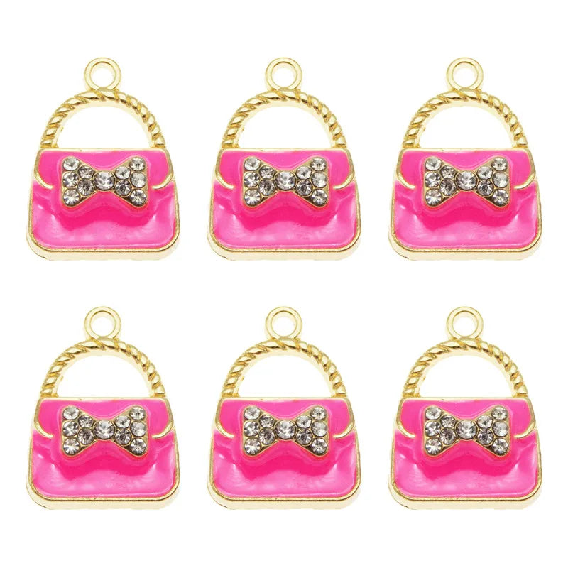 Set of six crystal enamel handbag charm pendants in pink and gold.