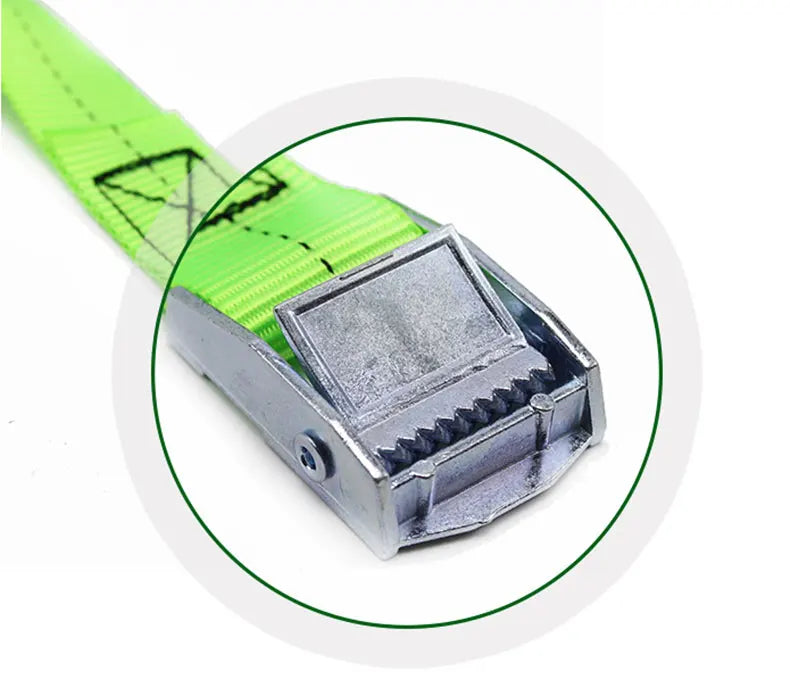 A close-up view of a bright green heavy-duty tie-down strap with a silver metal buckle.