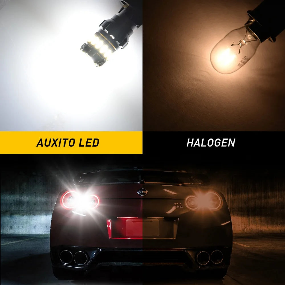 Comparison of Auxito LED and Halogen light bulbs, with a car's rear light visible.