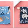 A blue cosmetic storage pouch with a cat design featuring various cats and related elements.