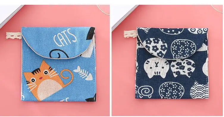 A blue cosmetic storage pouch with a cat design featuring various cats and related elements.