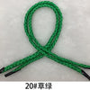 A green multi-color polypropylene gift string rope tied in a loop and crossed to form an 'X' shape.