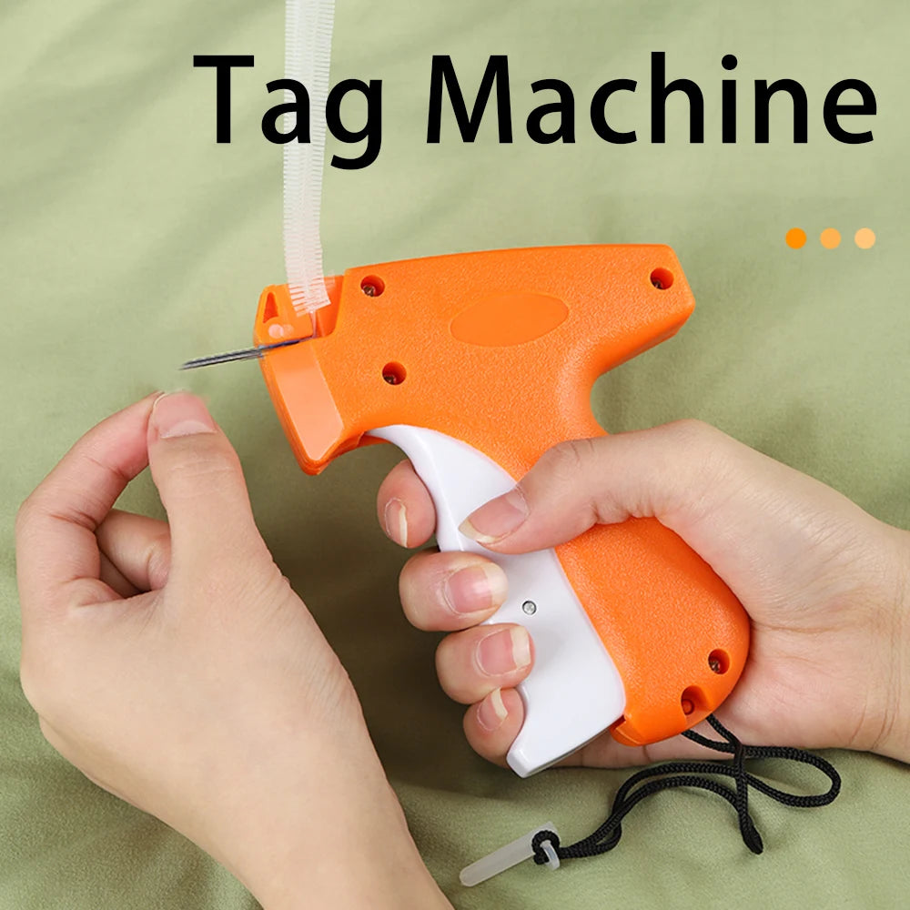 A hand is holding an orange and white tag machine device with a white tag being attached.