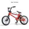 Red 1/10 scale RC mountain bike model with black components and wheels