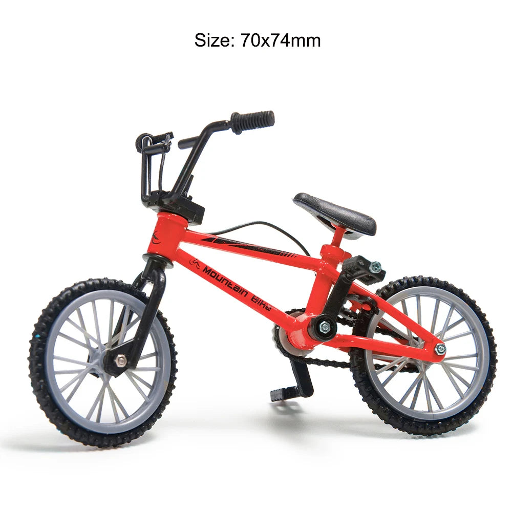 Red 1/10 scale RC mountain bike model with black components and wheels