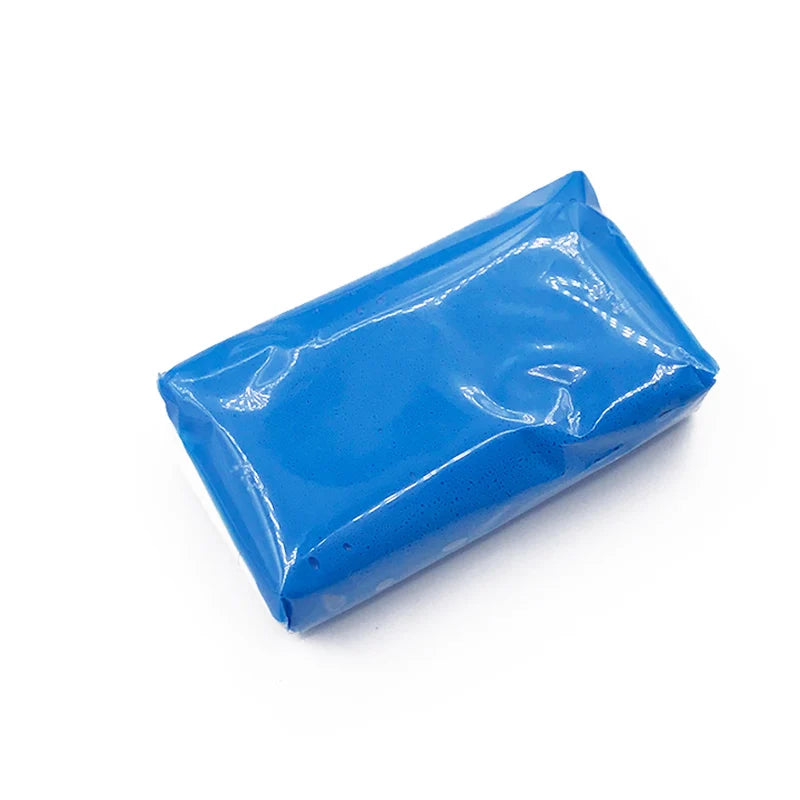 A blue plastic bag containing a professional magic clay bar for car detailing and paint decontamination.