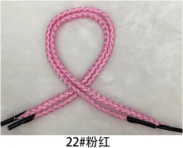 Pink multi-color polypropylene gift string rope tied in an 'X' shape.