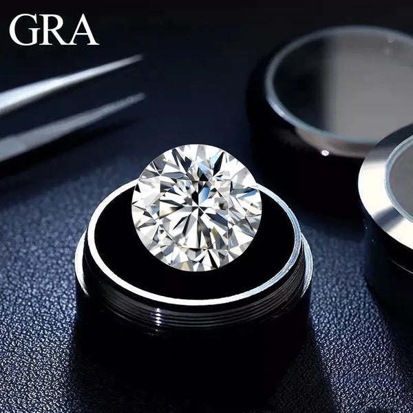 A round brilliant cut loose moissanite stone is displayed on a silver ring setting against a dark background.