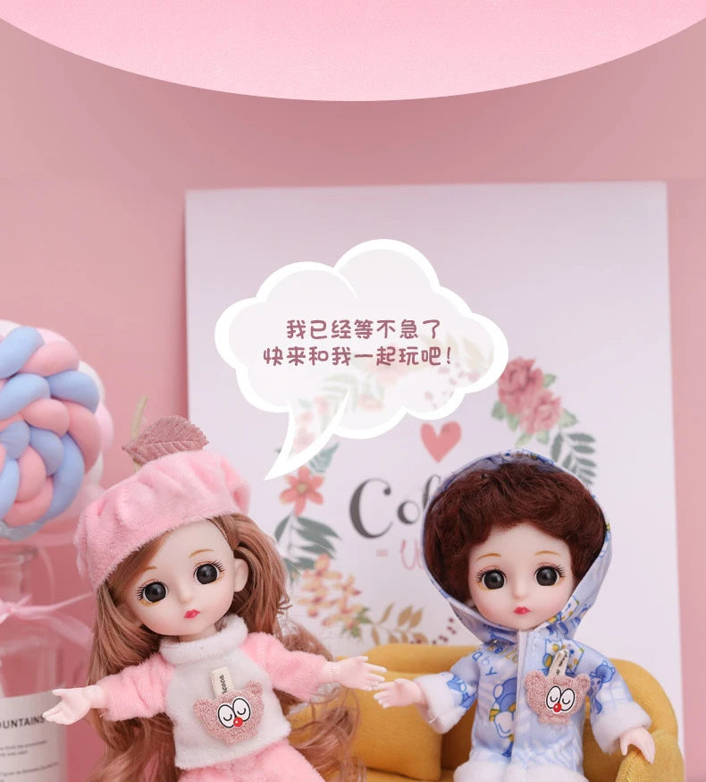 Two poseable fashion dolls with pink and blue hair and clothing displayed against a light pink background.