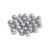 A pile of round silver-colored ABS imitation pearl beads for jewelry making.