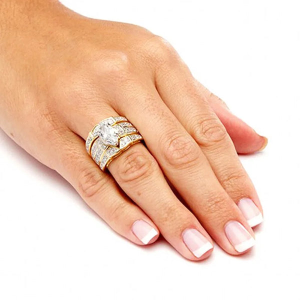 A hand wearing a vintage 14K gold marquise lab diamond bridal ring set on a finger.