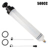 A clear plastic syringe with a black plunger and various clear tubes for manual fuel transfer or oil extraction.