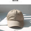 A beige classic cotton dad hat shown in a studio setting with natural lighting.