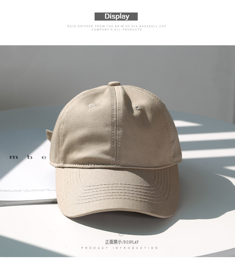 A beige classic cotton dad hat shown in a studio setting with natural lighting.
