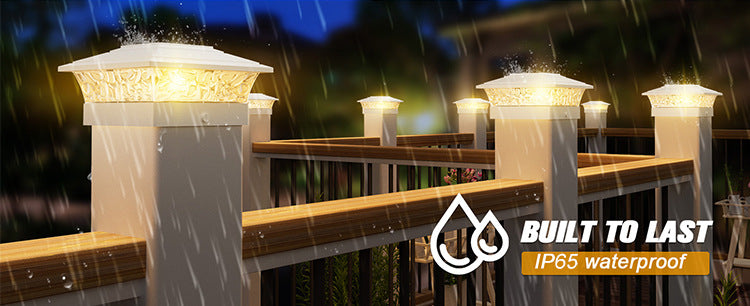 Outdoor solar post cap lights with warm LED illuminating a wooden fence and deck area.