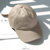 A beige classic cotton dad hat shown in a studio setting with shadows.
