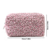 A rectangular cosmetic bag with a leopard print exterior and plush pink lining.