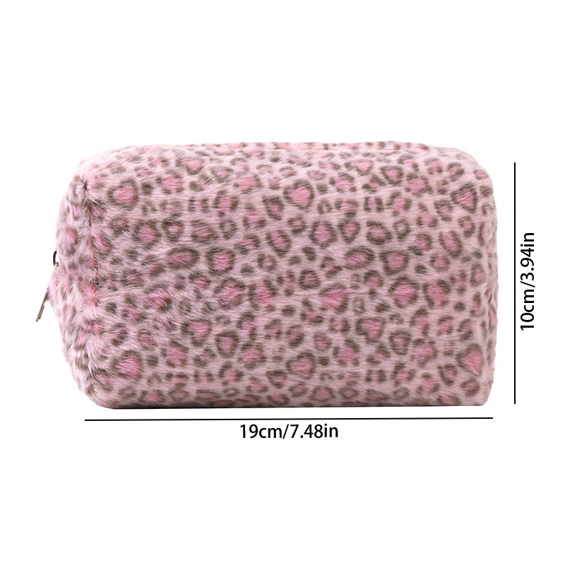 A rectangular cosmetic bag with a leopard print exterior and plush pink lining.