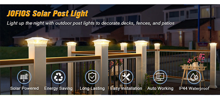 A row of white solar post lights illuminating a wooden fence and patio area at night.