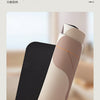 A roll of beige L-shaped crystal velvet kitchen mat with a black non-slip backing shown in a close-up view.