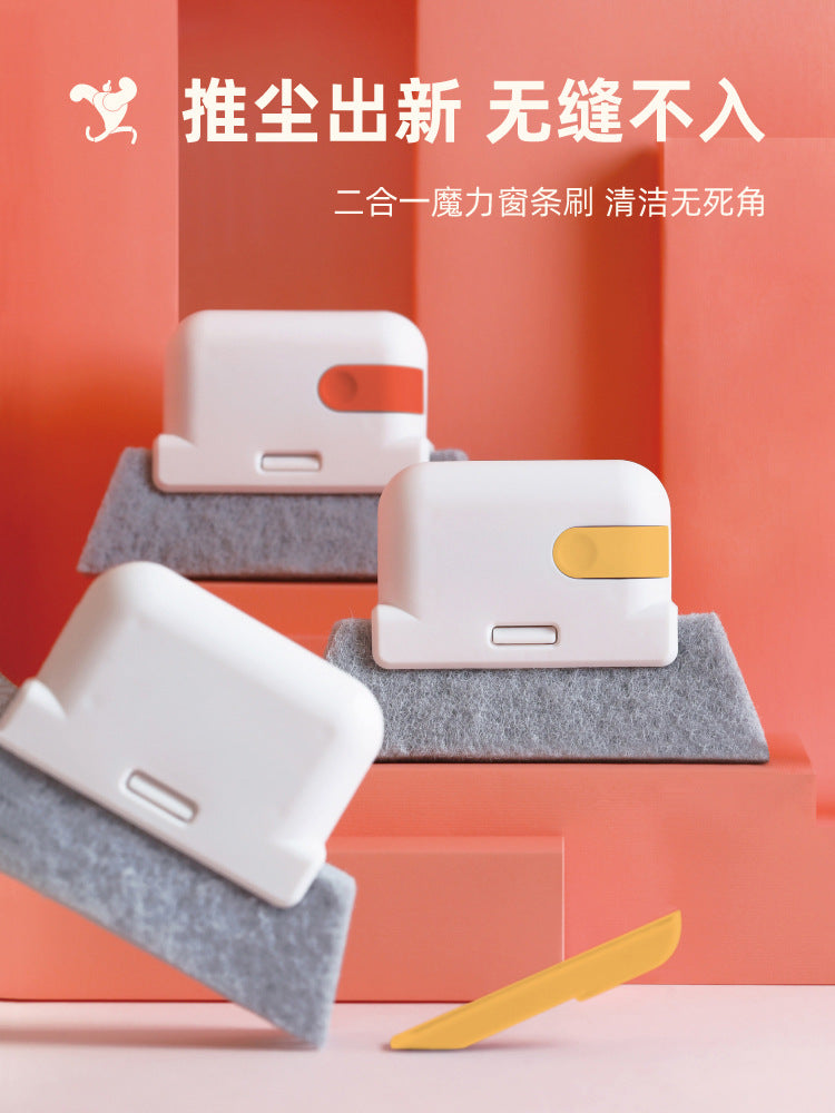 A white multi-surface gap cleaning brush with an orange scouring pad is displayed on a pink shelf.