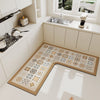 An L-shaped crystal velvet kitchen mat with a patterned design rests on a white countertop near a window.