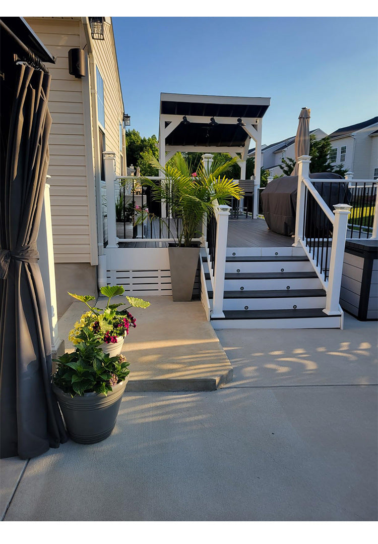 A set of solar post cap lights with warm LED illuminating a white fence and deck area.